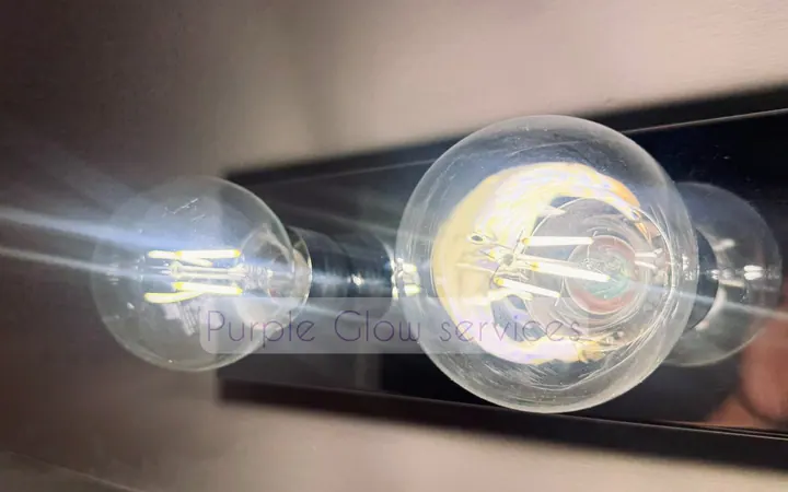 Before and after: dusty Edison bulbs wiped clear during a detail cleaning by Purple Glow Services