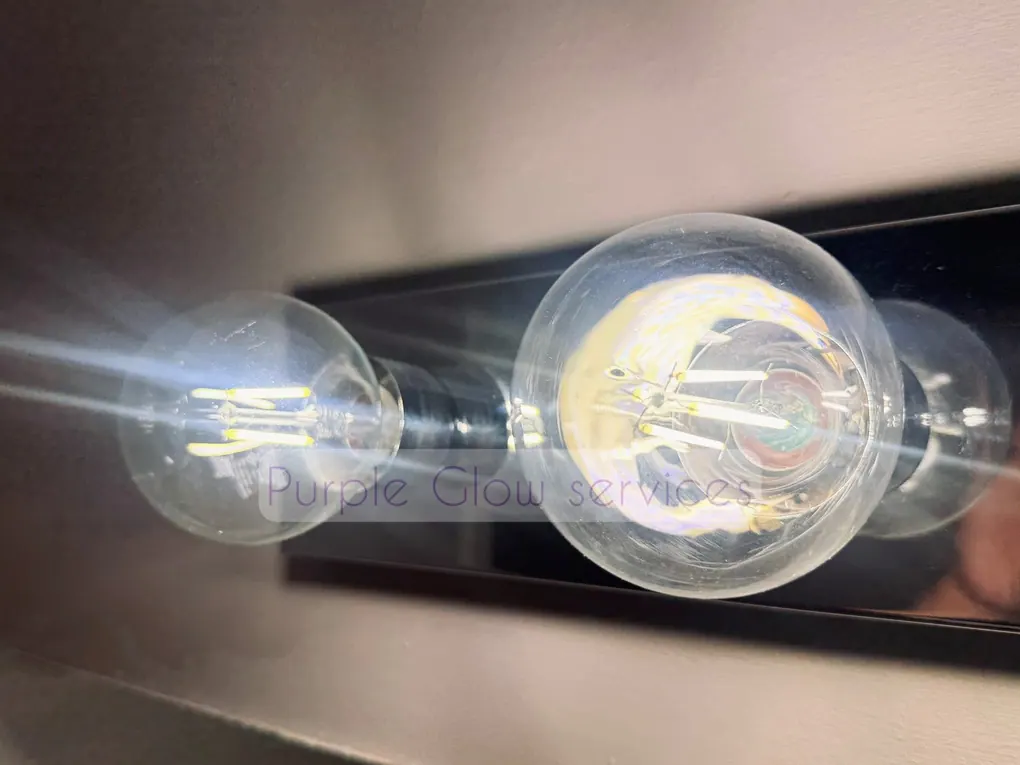 Before and after: dusty Edison bulbs wiped clear during a detail cleaning by Purple Glow Services
