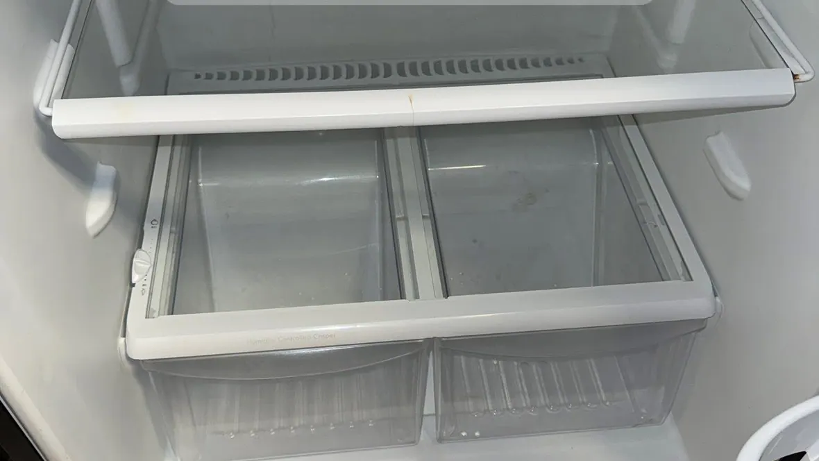 Empty refrigerator interior washed down with clean glass shelves during a move-out cleaning in Murfreesboro, TN