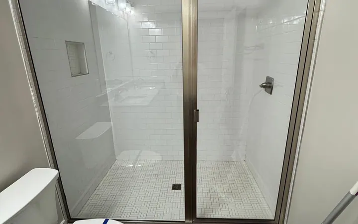 Before and after: a glass shower enclosure cleaned free of soap scum by Purple Glow Services in Murfreesboro, TN
