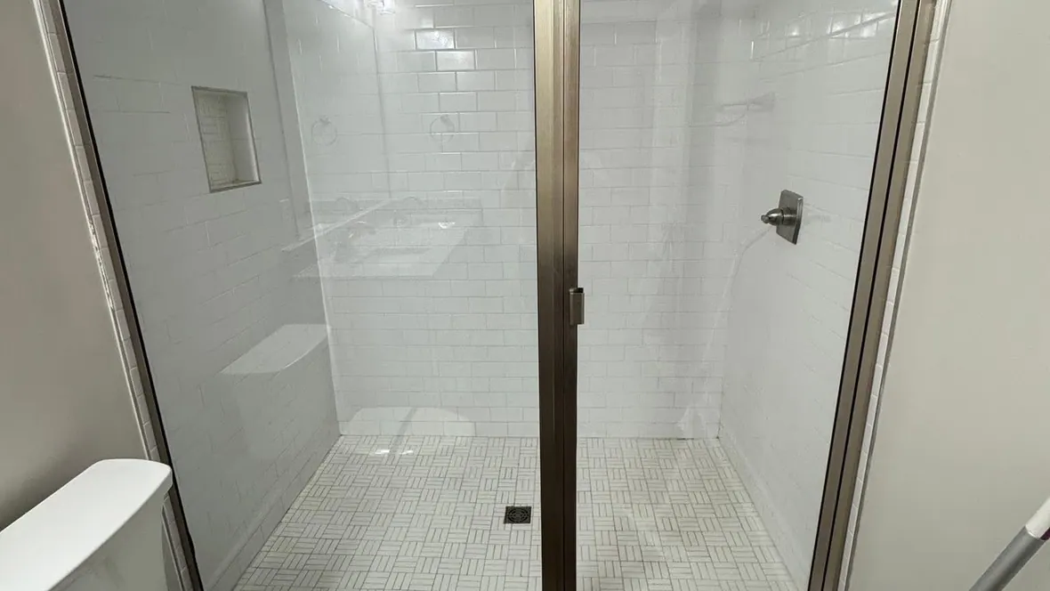 Before and after: a glass shower enclosure cleaned free of soap scum by Purple Glow Services in Murfreesboro, TN