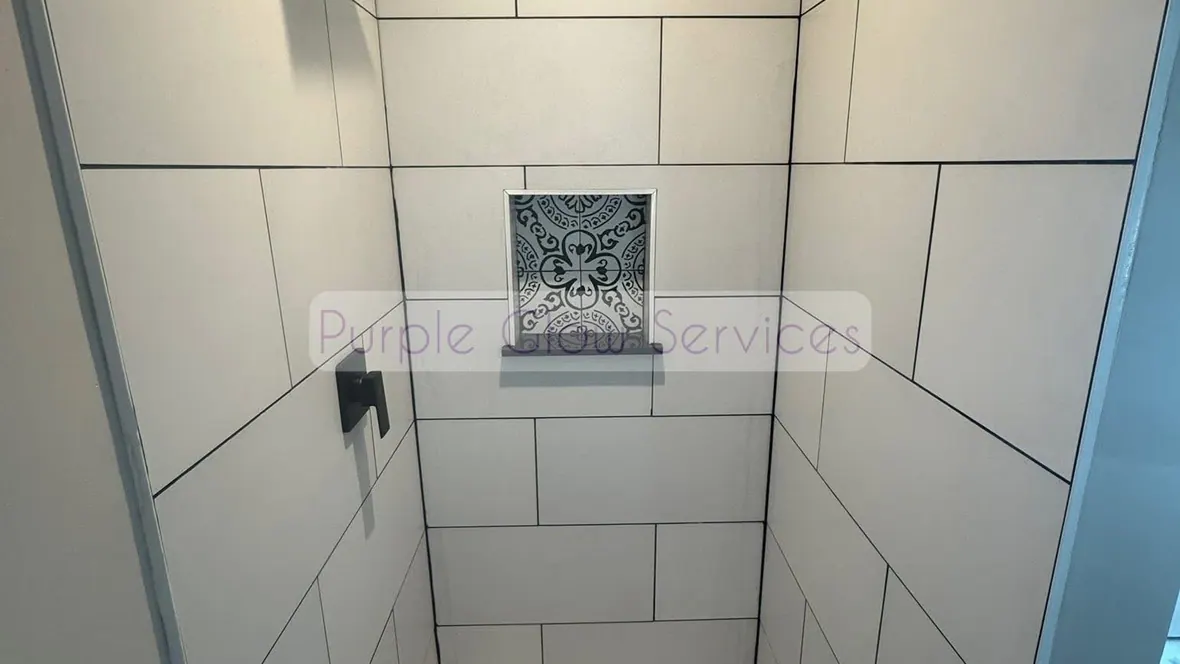 Freshly cleaned tiled walk-in shower with a hex tile floor and built-in niche in Murfreesboro, TN