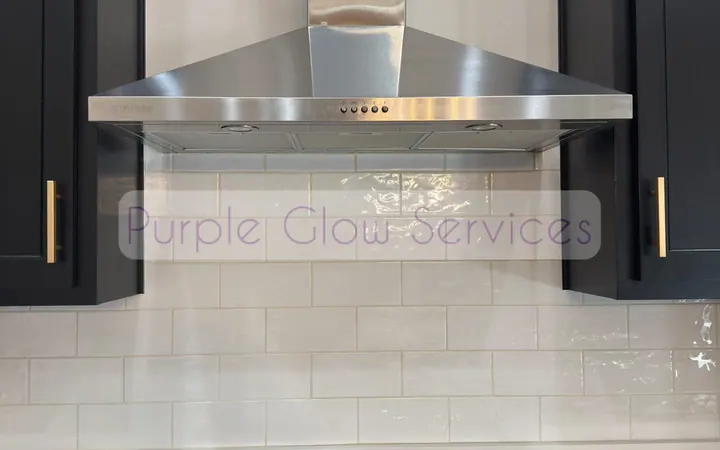 Stainless range hood, gas cooktop and white tile backsplash wiped down after a kitchen cleaning in Murfreesboro, TN