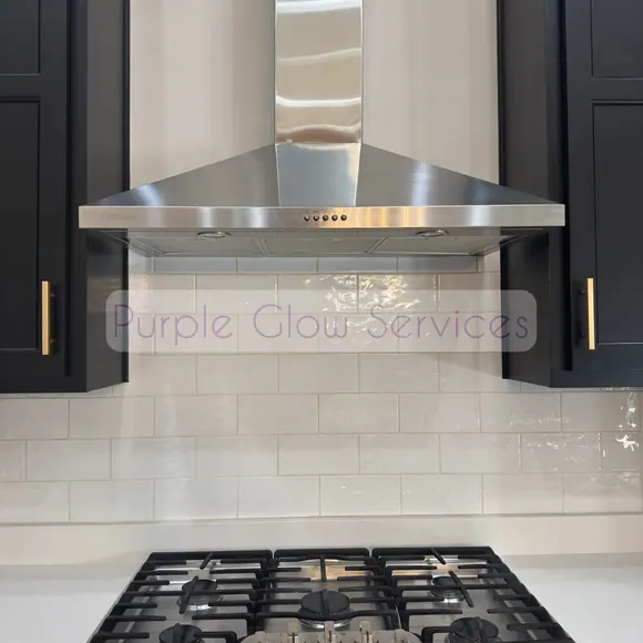 Stainless range hood, gas cooktop and white tile backsplash wiped down after a kitchen cleaning in Murfreesboro, TN