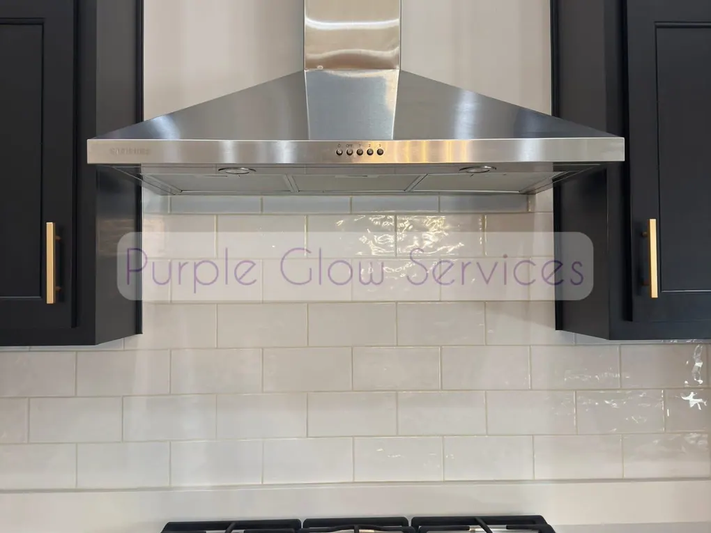 Stainless range hood, gas cooktop and white tile backsplash wiped down after a kitchen cleaning in Murfreesboro, TN