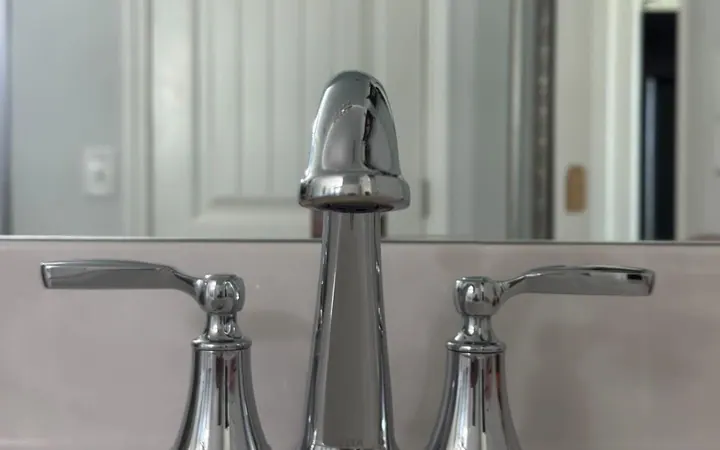 Polished chrome bathroom faucet on a spotless white vanity after a residential cleaning in Murfreesboro, TN