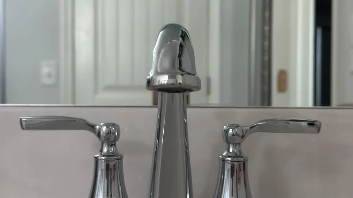 Polished chrome bathroom faucet on a spotless white vanity after a residential cleaning in Murfreesboro, TN