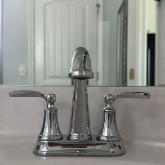 Polished chrome bathroom faucet on a spotless white vanity after a residential cleaning in Murfreesboro, TN