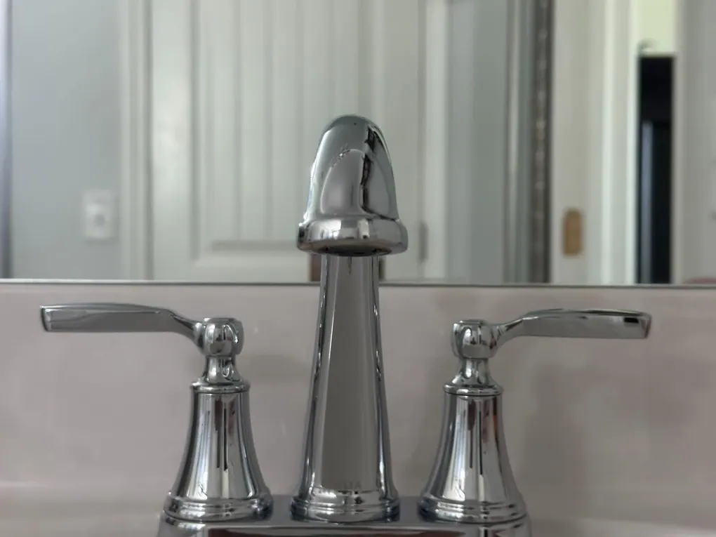 Polished chrome bathroom faucet on a spotless white vanity after a residential cleaning in Murfreesboro, TN